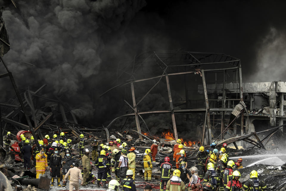 Firefighters work at the site of a massive explosion in Samut Prakan province, Thailand, Monday, July 5, 2021. The massive explosion at a factory on the outskirts of Bangkok damaged homes in the surrounding neighborhoods and prompted the evacuation of a wide area over fears of poisonous fumes from burning chemicals and the possibility of additional denotations. (AP Photo/Nava Natthong)