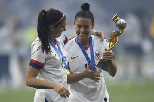 Ali Krieger (R) celebrates the US teams World Cup victory with fellow player Alex Morgan on July 7, 2019 in Lyon