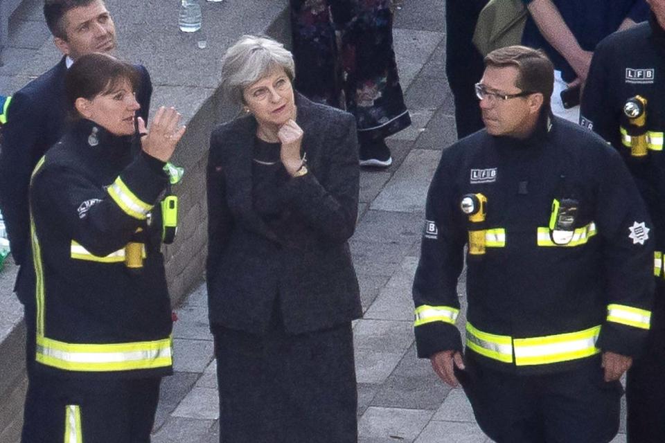 Commissioner Cotton speaks to then Prime Minister Theresa May at the site of the Grenfell Tower disaster (Getty Images)