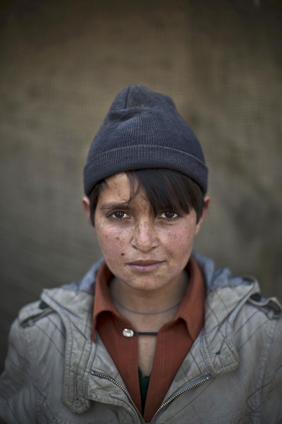 In this Saturday, Jan. 25, 2014 photo, Afghan refugee boy, Abdulrahman Bahadir, 13, poses for a picture, in a slum on the outskirts of Islamabad, Pakistan. For more than three decades, Pakistan has been home to one of the world’s largest refugee communities: hundreds of thousands of Afghans who have fled the repeated wars and fighting their country has undergone. Since the 2002 U.S.-led invasion of Afghanistan, some 3.8 million Afghans have returned to their home country, according to the U.N.’s refugee agency. (AP Photo/Muhammed Muheisen)