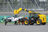 Alpha Tauri car of Daniil Kvyat of Russia is carried off track after crashing during the British Formula One Grand Prix at the Silverstone racetrack, Silverstone, England, Sunday, Aug. 2, 2020. (Andrew Boyers/Pool via AP)