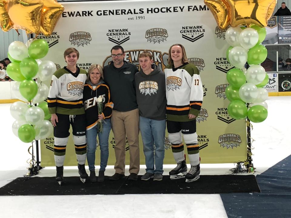 John Glenn's Logan Williams (left) poses with his family Thursday while honored on Senior Night for the Newark Generals. Younger brother Mason (right) also plays for the team.