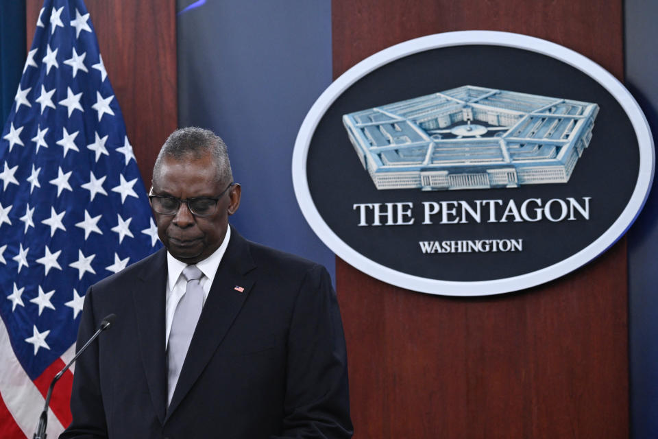 Lloyd Austin stands at a microphone in front of an American flag and a plaque that reads: The Pentagon, Washington