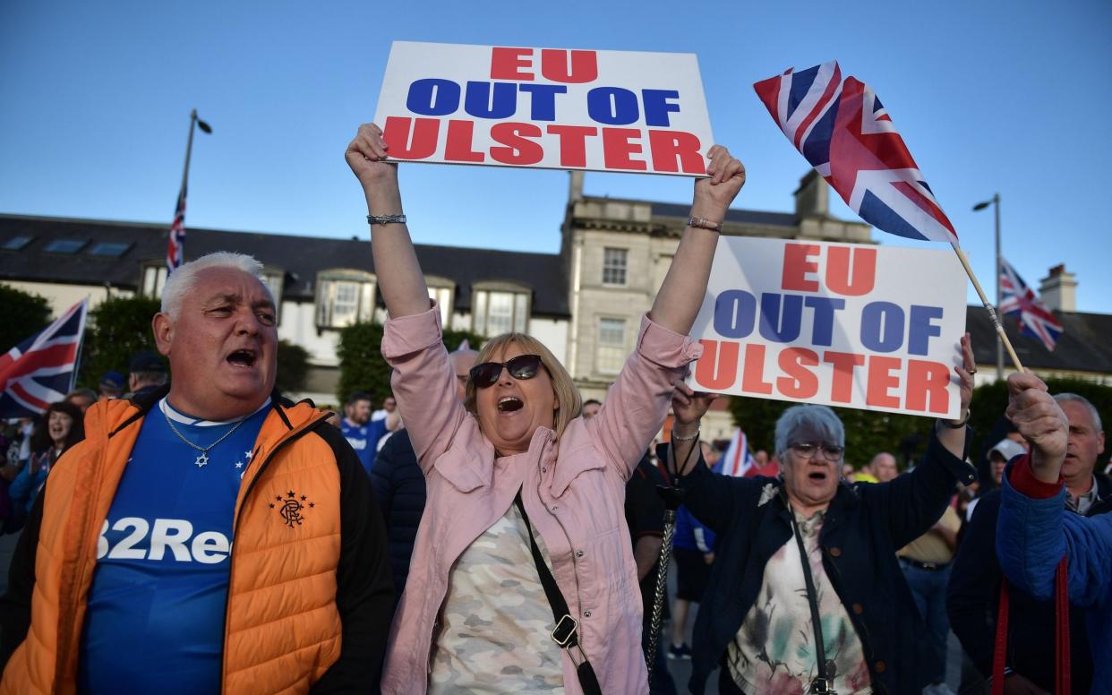 Loyalist band members and supporters make their way through Newtownards town centre during an anti-Northern Ireland Protocol protest rally on June 18 - Charles McQuillan/Getty