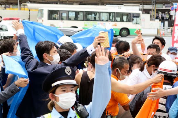 PHOTO: People react after gunshots in Nara, western Japan Friday, July 8, 2022. Japan’s former Prime Minister Shinzo Abe was in heart failure after apparently being shot during a campaign speech Friday in western Japan, NHK public television said Friday. (Kyodo News via AP)
