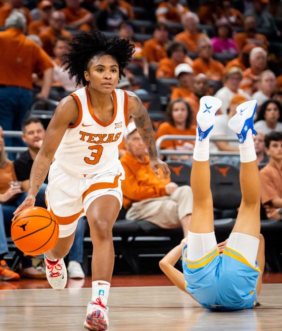 Texas guard Rori Harmon (3) dribbles away after the Southern University defender guarding her goes down in the first half of the Longhorns' game against the Jaguars at the Moody Center in Austin, Nov. 8, 2023. Texas won the game 80-35.