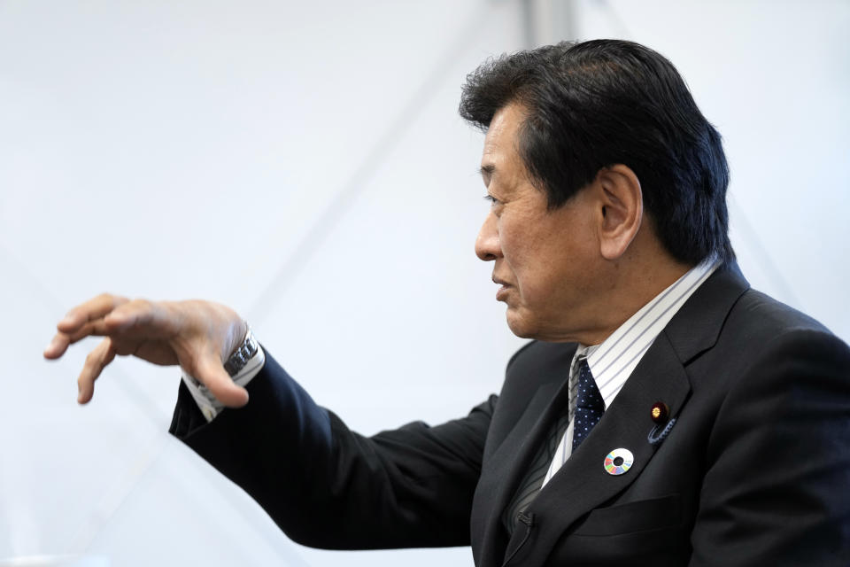 Japanese Environment Minister Tsuyoshi Yamaguchi speaks during an interview with The Associated Press Tuesday, Jan. 18, 2022, in Tokyo. Japan will gradually phase out coal plants over the next two decades while developing new technologies to reduce, capture and utilize carbon, Yamaguchi said Tuesday. (AP Photo/Eugene Hoshiko)