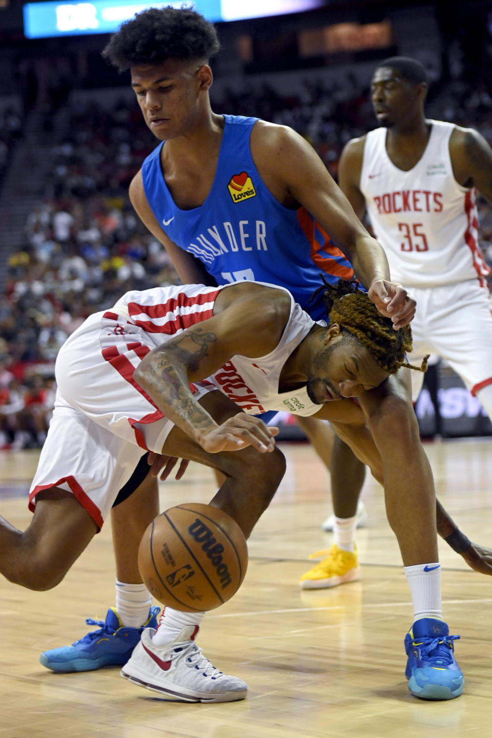 Houston Rockets' Trhae Mitchell (40) drives the ball against Oklahoma City Thunder's Ousmane Dieng (13) during the first half of an NBA summer league basketball game Saturday, July 9, 2022, in Las Vegas. (AP Photo/David Becker)