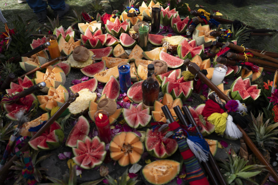 Fruit and candles are part of an altar for an Indigenous ceremony honoring Guatemala's new President Bernardo Arévalo at the sacred Mayan site of Kaminaljuyu in Guatemala City, Jan. 16, 2024. Arévalo was inaugurated as Guatemala's new president on Monday. (AP Photo/Moises Castillo)