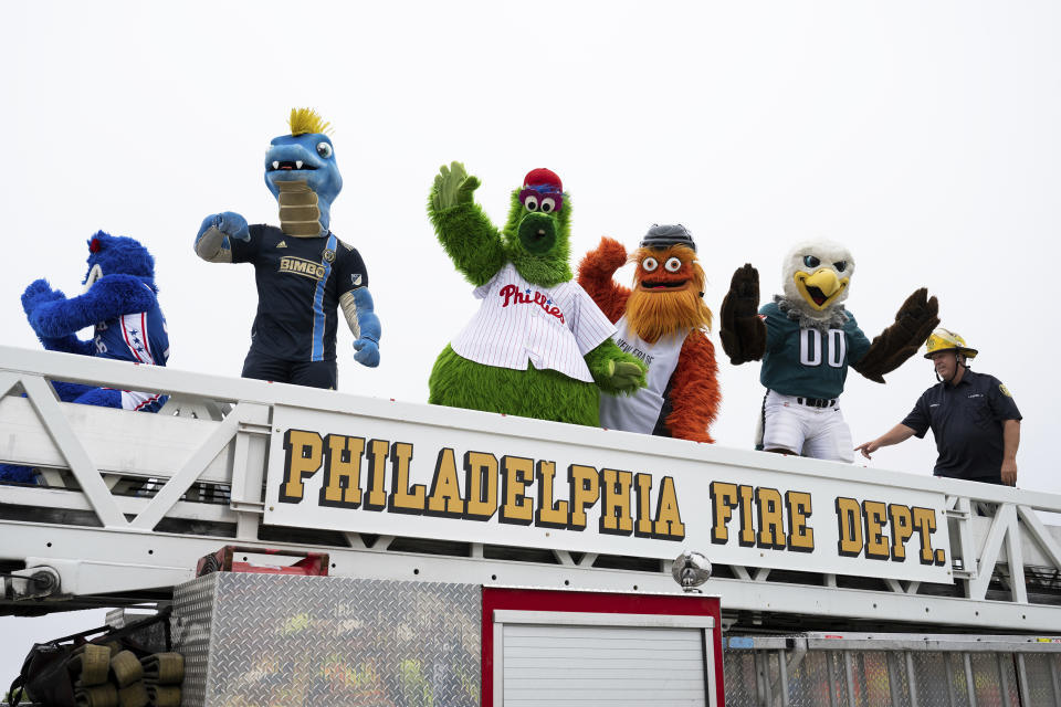 Mascots from professional Philadelphia sports teams cross over the repaired section of Interstate 95 as the highway is reopened Friday, June 23, 2023 in Philadelphia. Workers put the finishing touches on an interim six-lane roadway that will serve motorists during construction of a permanent bridge. (AP Photo/Joe Lamberti)