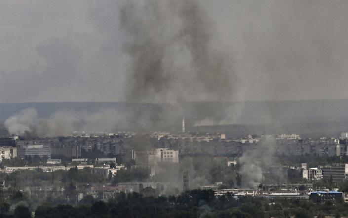 Smoke and dirt rise from the city of Severodonetsk in the eastern Ukrainian region of Donbas on June 17, 2022. - Aris Messinis/AFP