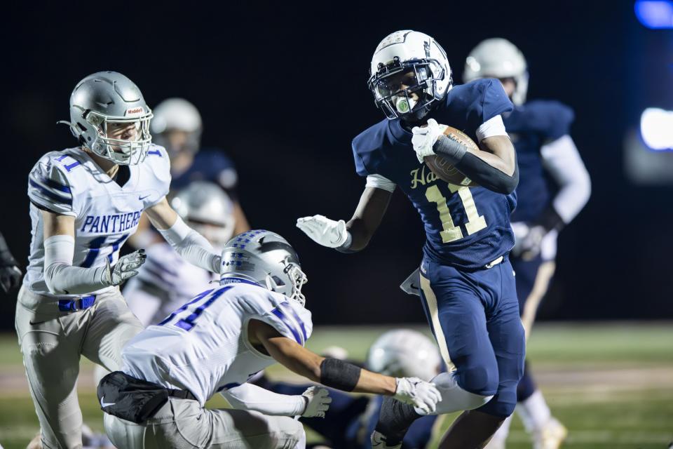 Decatur High School junior N'po Dodo (11) runs the all into the Bloomington South High School defense during the first half of an IHSAA Class 5A Semi-State football game, Friday, Nov. 17, 2023, at Decatur Central High School.