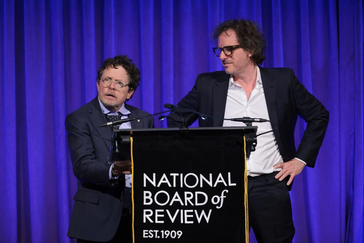 Michael J. Fox, left, and "Still" director Davis Guggenheim speak onstage at the National Board of Review dinner.