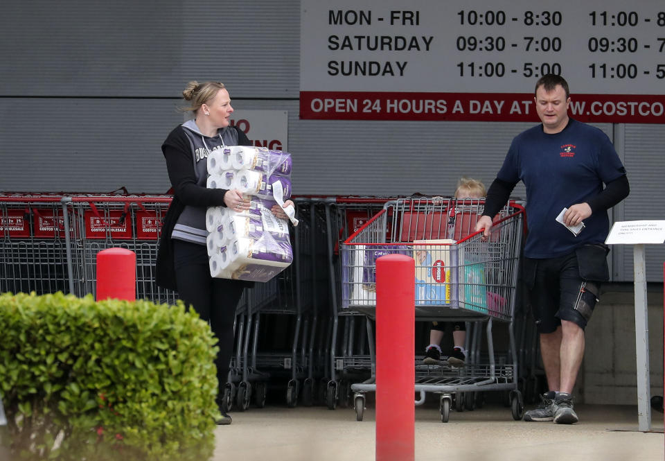 People stock up on food and toilet rolls at Costco in Farnborough, the day after Prime Minister Boris Johnson called on people to stay away from pubs, clubs and theatres, work from home if possible and avoid all non-essential contacts and travel in order to reduce the impact of the coronavirus pandemic. (Photo by Steve Parsons/PA Images via Getty Images)