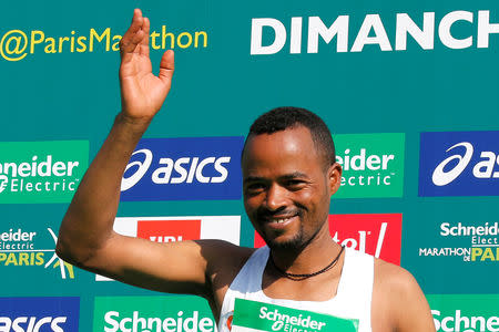 Athletics - Paris Marathon - Paris, France - April 14, 2019 Ethiopia's Abrha Milaw Asefa celebrates winning the men's elite race on the podium REUTERS/Regis Duvignau