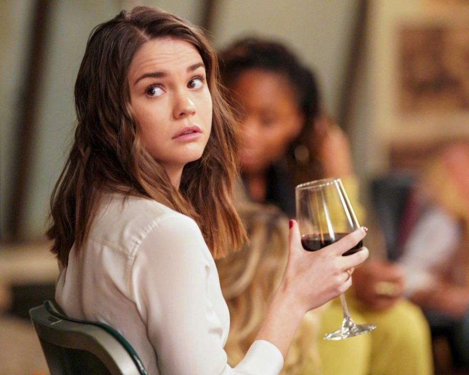 maia mitchell in good trouble holding a glass of wine