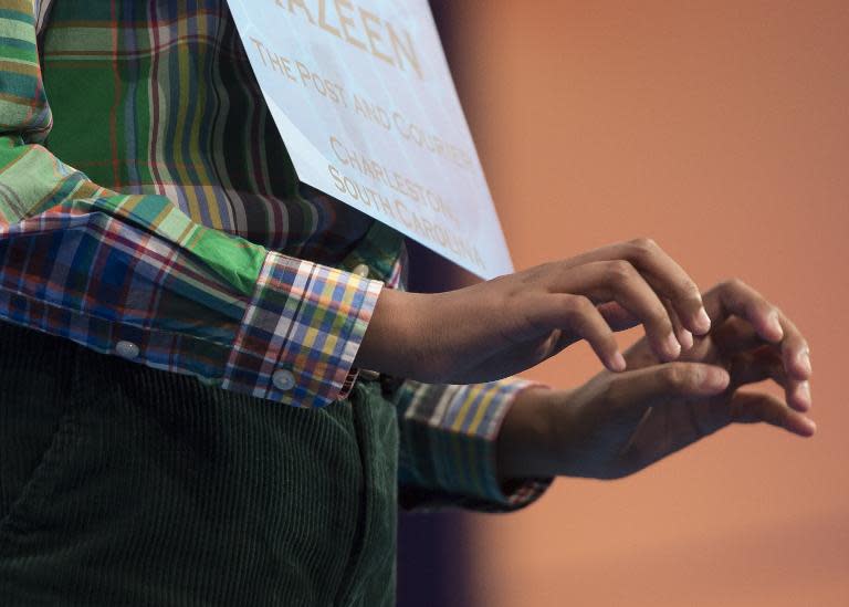 Razeen Basunia of North Charleston, South Carolina, pretends to type out his word, "pileus," during the 3rd round of the 88th Annual Scripps National Spelling Bee at National Harbor, Maryland, May 27, 2015