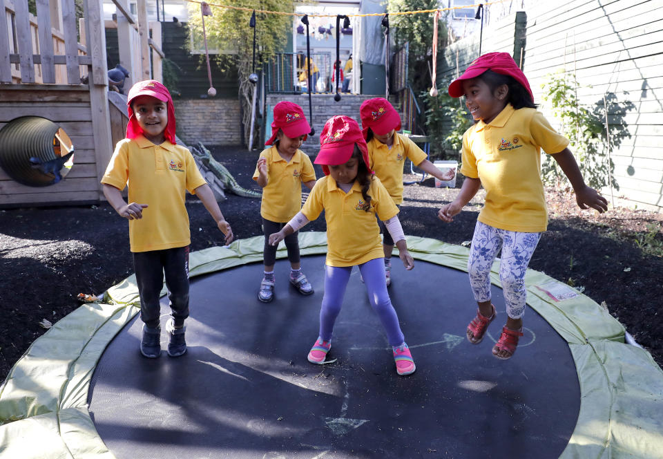 Children jump on a trampoline at the Little Darling home-based Childcare after nurseries and primary schools partly reopen in England after the COVID-19 lockdown in London, Monday, June 1, 2020. (AP Photo/Frank Augstein)