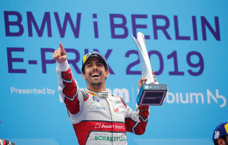 Motorsport - Formula E - Berlin ePrix - Berlin-Tempelhof, Berlin, Germany - May 25, 2019 Audi Sport Abt Schaeffler's Lucas Di Grassi celebrates winning the race with the trophy on the podium