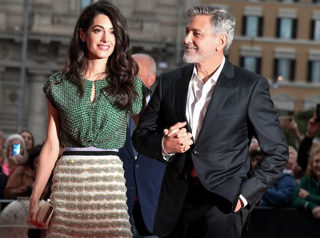 TIZIANA FABI/AFP/Getty George and Amal Clooney