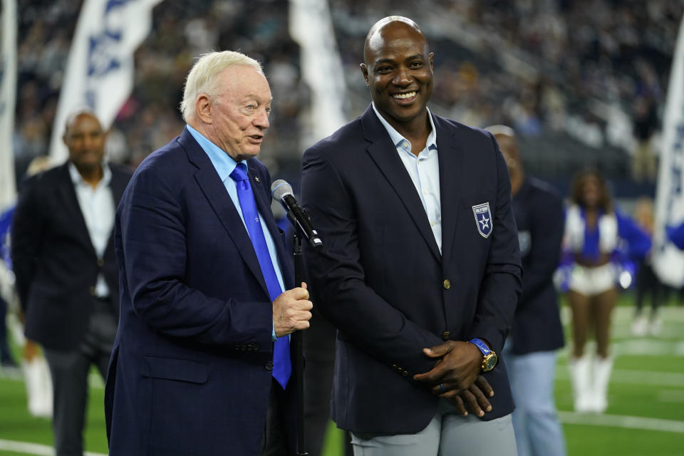 Former Dallas Cowboys player DeMarcus Ware, right, smiles next to Cowboys owner Jerry Jones during halftime ring of honor ceremony to honor Ware in an NFL football game between the Cowboys and Los Angeles Rams Sunday, Oct. 29, 2023, in Arlington, Texas. (AP Photo/Julio Cortez)