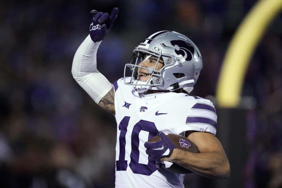 Kansas State wide receiver Keagan Johnson (10) celebrates after scoring a touchdown during the first half of an NCAA college football game against Kansas Saturday, Nov. 18, 2023, in Lawrence, Kan. (AP Photo/Charlie Riedel)