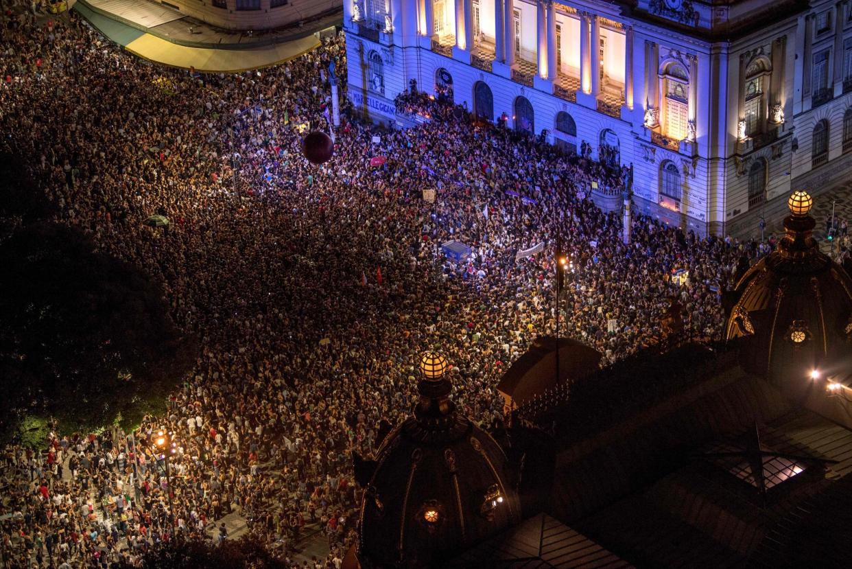 Brazilians gathered to mourn the popular councilwoman (AFP): AFP/Getty Images