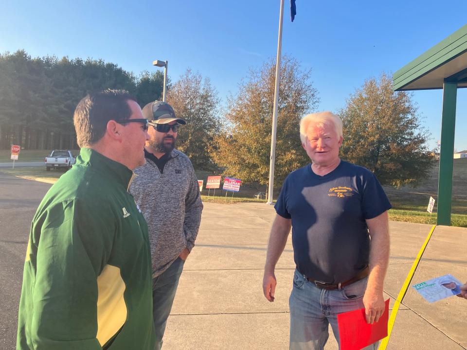 Tim Swortzel (green jacket), who is running for school board in Augusta County, talks with a voter.