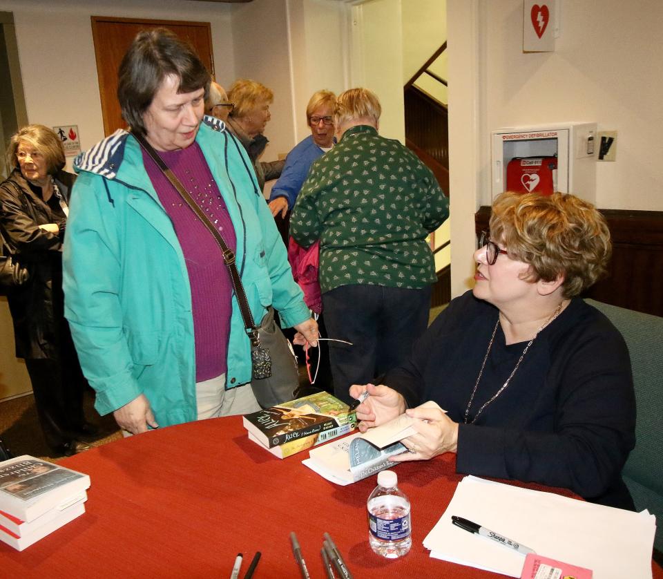 Author Melanie Benjamin, right, speaks with Vicky Kugler, left, as she prepares to sign a copy of her book, "The Children's Blizzard," following Benjamin's talk Thursday, March 23, 2023, at Union Avenue United Methodist Church. Benjamin's book was Alliance's One Book One Community selection for 2023.