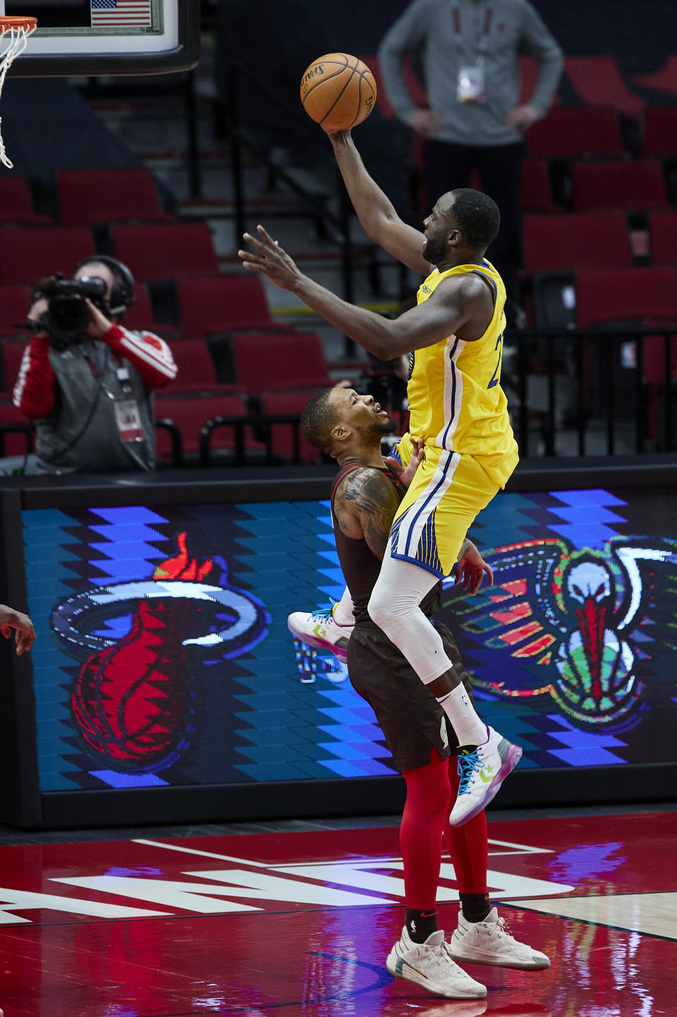 Portland Trail Blazers guard Damian Lillard, left, takes a charge from Golden State Warriors forward Draymond Green in the final seconds of the second half of an NBA basketball game in Portland, Ore., Wednesday, March 3, 2021. (AP Photo/Craig Mitchelldyer)