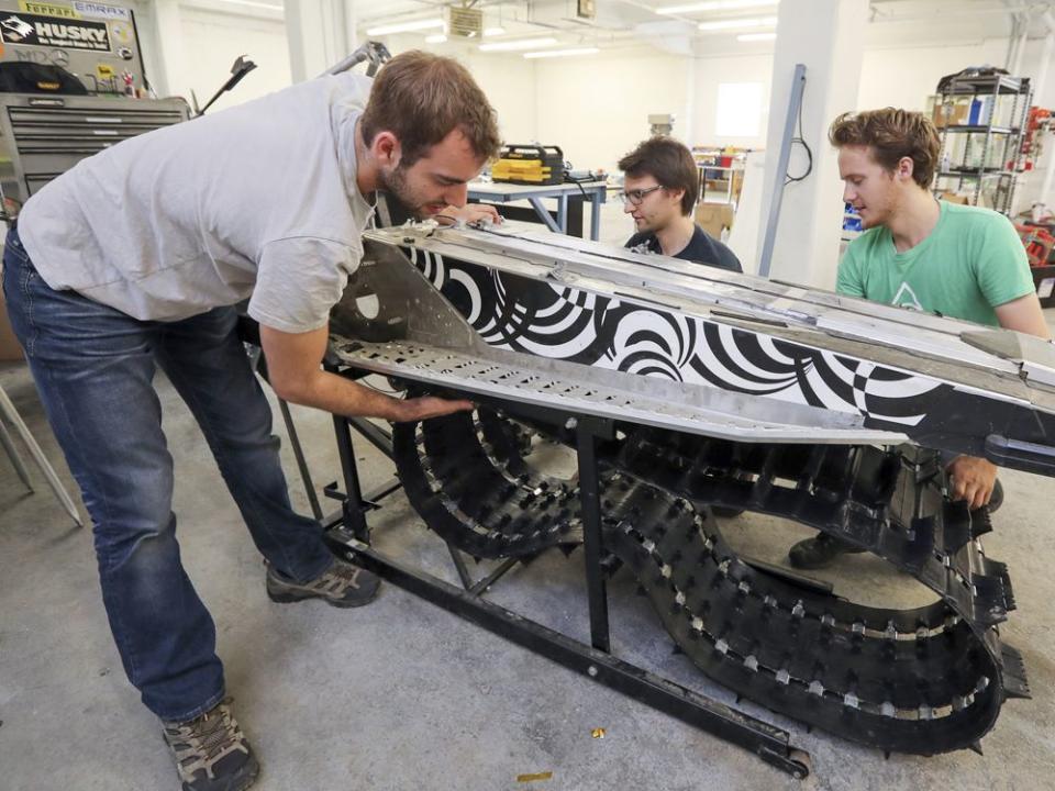  Taiga co-founders Gabriel Bernatchez, left, Paul Achard and Bruneau working on the prototype of their electric snowmobile at their workshop in Montreal in 2017.