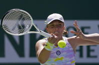 Iga Swiatek, of Poland, returns a shot to Maria Sakkari, of Greece, during the women's singles finals at the BNP Paribas Open tennis tournament Sunday, March 20, 2022, in Indian Wells, Calif. (AP Photo/Mark J. Terrill)