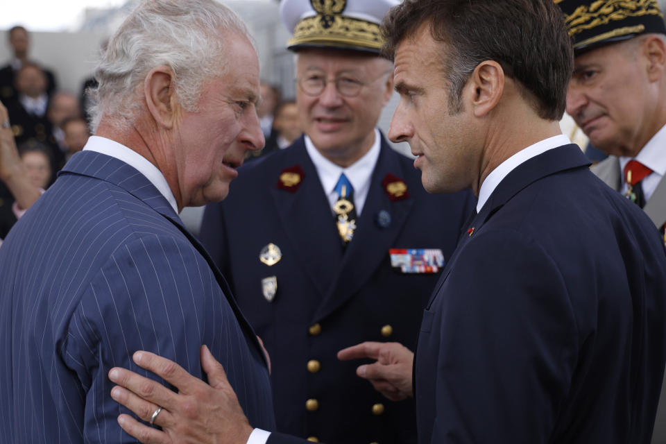 Britain's King Charles III, left, listens to French President Emmanuel Macron during a ceremony at the Arc de Triomphe, Wednesday, Sept.20, 2023 in Paris. King Charles III of the United Kingdom starts a three-day state visit to France on Wednesday meant to highlight the friendship between the two nations with great pomp, after the trip was postponed in March amid widespread demonstrations against President Emmanuel Macron's pension changes. (Yoan Valat, Pool via AP)