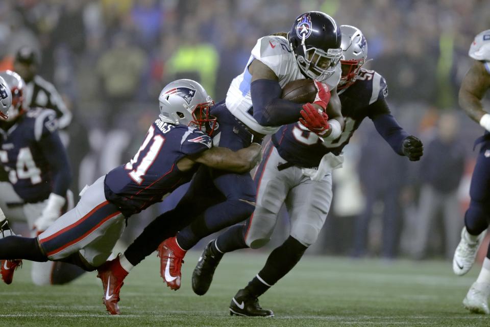 New England Patriots defensive back Jonathan Jones, left, tries to bring down Tennessee Titans running back Derrick Henry in the first half of an NFL wild-card playoff football game, Saturday, Jan. 4, 2020, in Foxborough, Mass. (AP Photo/Charles Krupa)