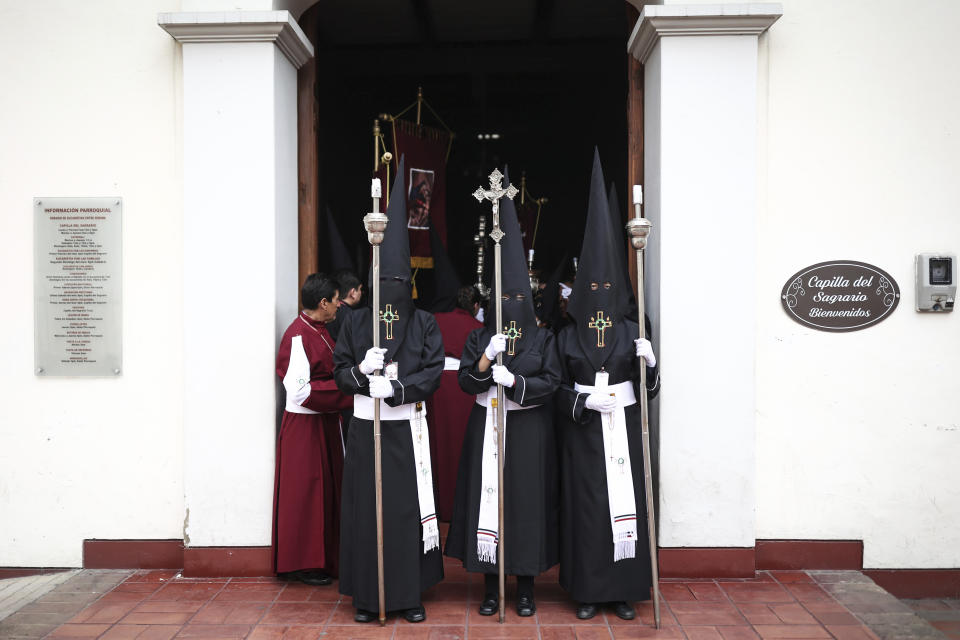 Members of the Nazarene brotherhood take part in a Holy Week procession, in Zipaquira, Colombia, Friday, March 29, 2024. Holy Week commemorates the last week of Jesus' earthly life which culminates with his crucifixion on Good Friday and his resurrection on Easter Sunday. (AP Photo/Ivan Valencia)