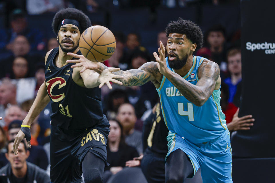 Cleveland Cavaliers center Jarrett Allen (31) and Charlotte Hornets center Nick Richards (4) battle for a loose ball during the first half of an NBA basketball game in Charlotte, N.C., Wednesday, March 27, 2024. (AP Photo/Nell Redmond)