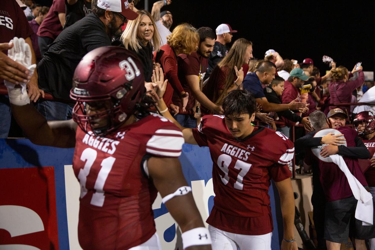 NMSU football players celebrate their win against UNM on Saturday, Oct. 15, 2022, at Aggies Memorial Stadium. They defeated their rival 21-9. 