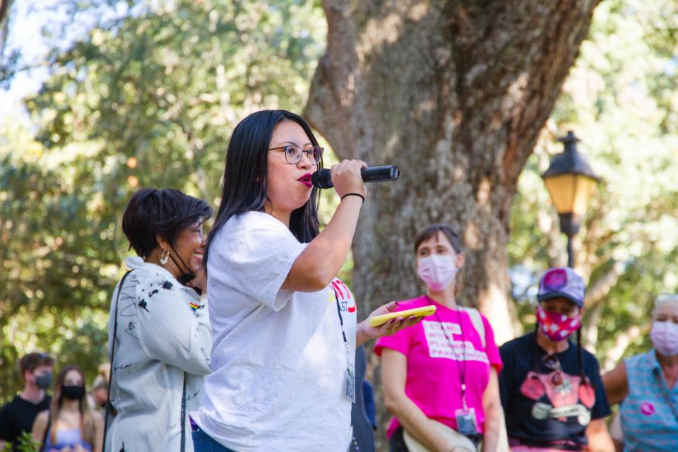 Migrant Equity Organizer Daniela Rodriguez speaks to crowd during the Women's March held at Forsyth Park.