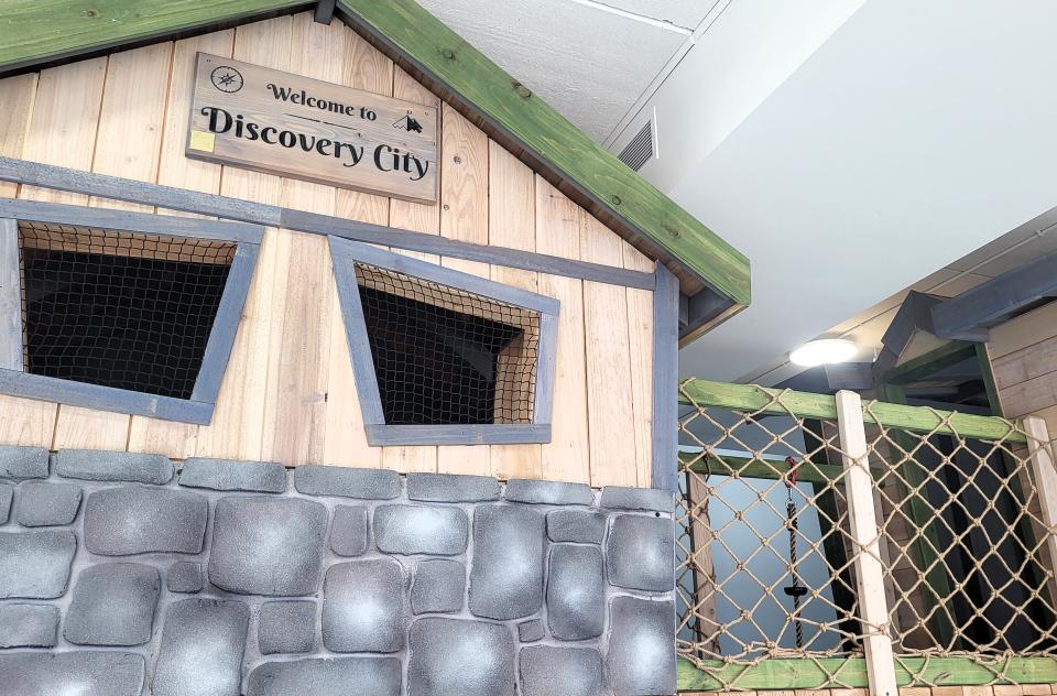 A sign on a treehouse-like playscape, shown on Tuesday, March 19, 2024, at 317 Grand River Ave., welcomes eventual visitors to the Discovery City Children's Museum in downtown Port Huron.