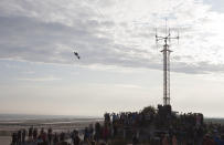 Franky Zapata, a 40-year-old inventor, takes to the air in Sangatte, Northern France, at the start of his attempt to cross the channel from France to England, aboard his flyboard, Sunday Aug. 4, 2019. Zapata will try again Sunday, to traverse the English Channel on a flying board after his first attempt failed when he crashed into a refueling boat 20 kilometers (12 miles) into the trip. (AP Photo/Michel Spingler)