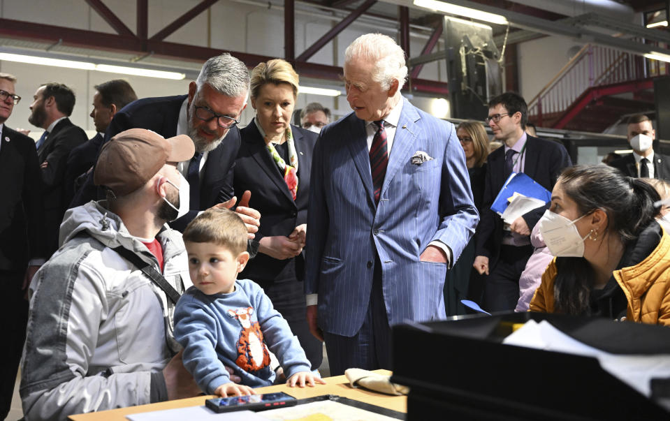 Britain's King Charles III visits the arrival center for refugees from Ukraine at the former Tegel Airport together with Franziska Giffey, Governing Mayor of Berlin, on the second day of his visit to Germany in Berlin, Thursday, March 30, 2023. (Bernd von Jutrczenka//DPA via AP, Pool)