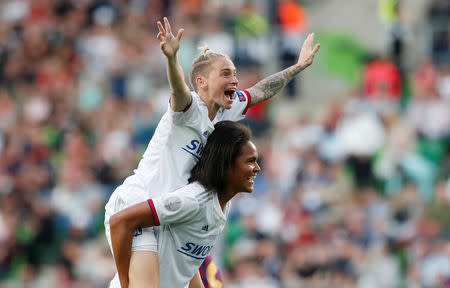 Soccer Football - Women's Champions League Final - Ferencvaros Stadium, Budapest, Hungary - May 18, 2019 Olympique Lyonnais' Wendie Renard celebrates winning the Women's Champions League with Jess Fishlock after the match REUTERS/Bernadett Szabo