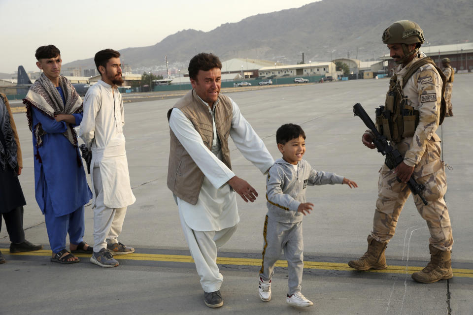 Afghans prepare to to be evacuated aboard a Qatari transport plane, at Hamid Karzai International Airport in Kabul, Afghanistan, August, 18, 2021. Qatar played an out-sized role in U.S. efforts to evacuate tens of thousands of people from Afghanistan. Now the tiny Gulf Arab state is being asked to help shape what is next for Afghanistan because of its ties with both Washington and the Taliban insurgents now in charge in Kabul. (Qatar Government Communications Office via AP)