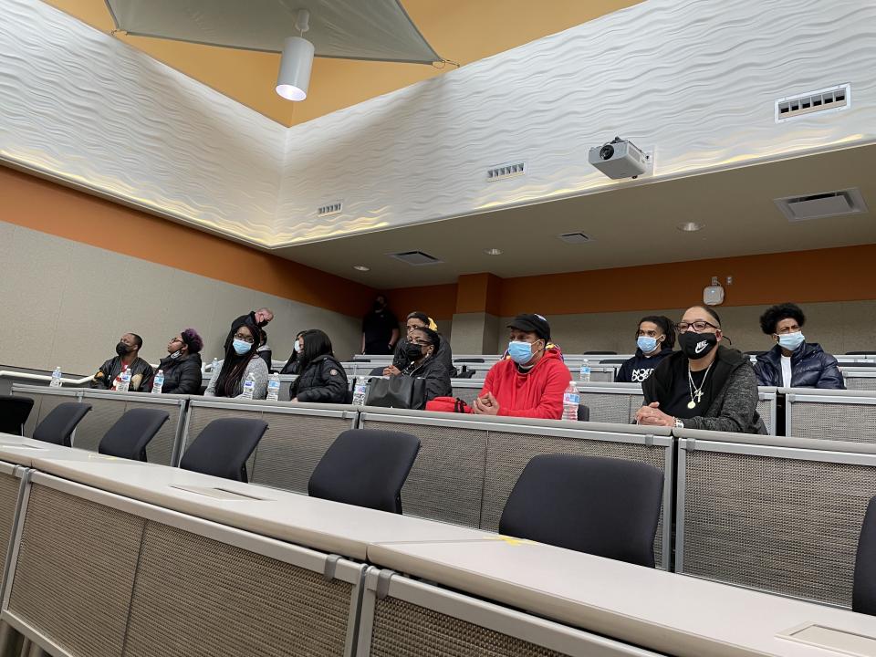 Family and friends of Tyesha Bell watch as police announce during a press conference that her remains had been found in Kane County on Tuesday, March 16, 2021 in Aurora, Ill. Authorities say human remains found last year in a wooded area of Chicago’s western suburbs have been identified as Bell, an Aurora mother reported missing in 2003. Aurora Police said Tuesday, March 16, 2021, that Illinois State Police’s crime lab identified Tyesha Bell’s remains through DNA analysis. (Megan Jones/Chicago Tribune via AP)