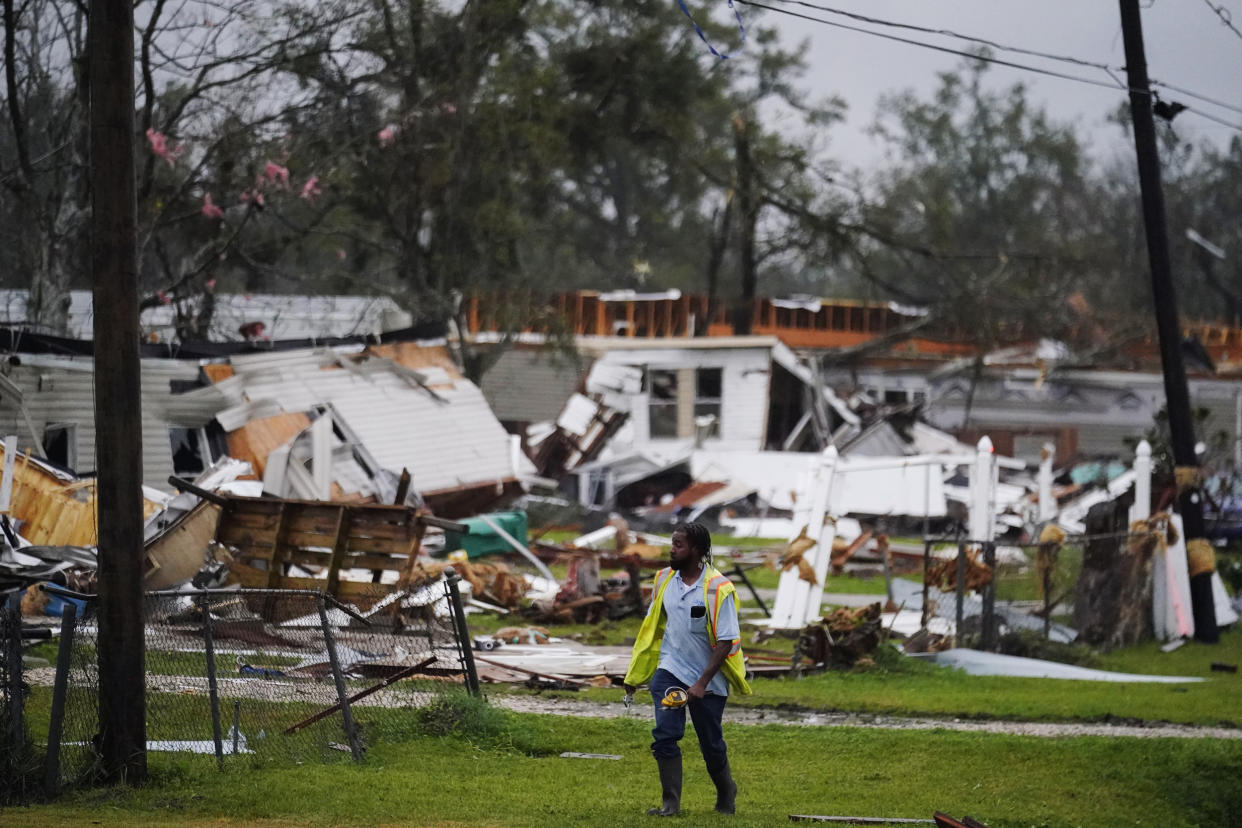 An Atmos Energy employee checks on gas lines after a tornado tore through the area in Killona, La., about 30 miles west of New Orleans in St. James Parish, on Dec. 14, 2022.  (Gerald Herbert / AP)