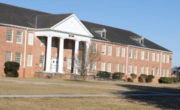 Brown Hall is a contributing element in the Grambling State University Historic District. A broad and commanding two-story red brick building is a former dormitory which culminates in a central colossal Tuscan pedimented portico. The tympanum features a modillion cornice and an oculus at the center. The extensive hip roof features ventilating dormers and a modillion cornice.