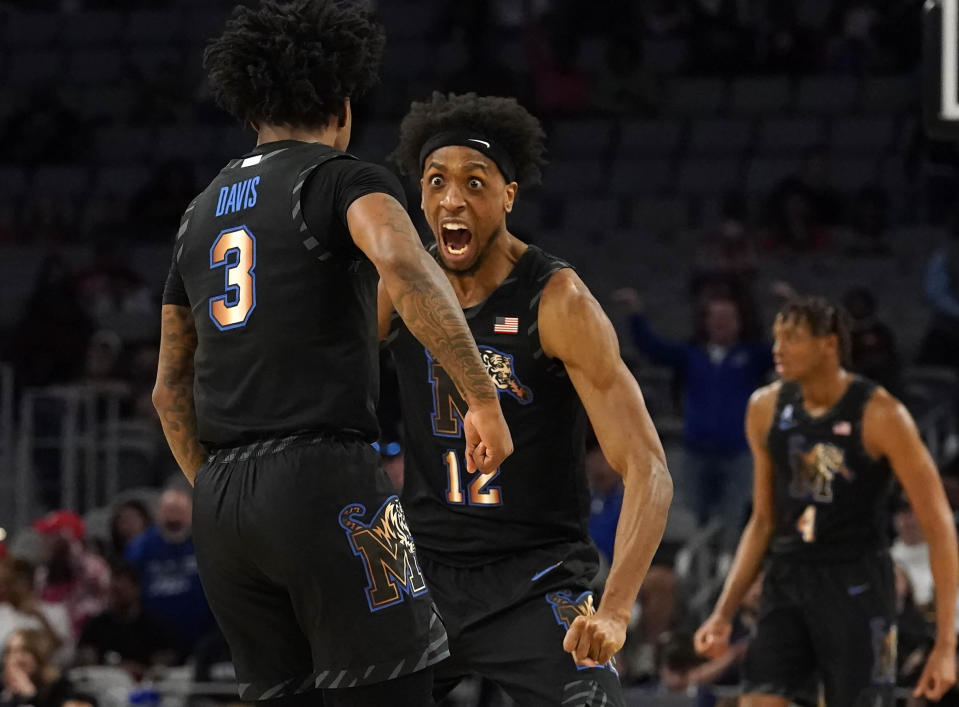 Memphis forward DeAndre Williams (12) and guard Kendric Davis (3) celebrate after a play during the first half against Houston in the finals of the American Athletic Conference Tournament, Sunday, March 12, 2023, in Fort Worth, Texas. (AP Photo/LM Otero)