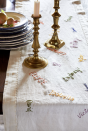 <p>Take inspiration from television personality and cookbook author Nancy Fuller, whose linen table runner features the signatures of family members. To create your own version, have family members write their names with a disappearing ink pen, and then stitch over the hand-lettering.<br></p>