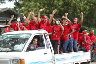 FILE - Supporters wearing shirts with logos of the Myanmar leader Aung San Suu Kyi's National League for Democracy (NLD) cheer from a truck as they take part in the final day of campaigning for the Nov. 8 elections in Data township, Yangon, Myanmar Nov. 6, 2020. Suu Kyi is the daughter of the country’s independence hero, Gen. Aung San, who was assassinated in 1947, less than six months before the country, then called Burma, became independent from Britain. Suu Kyi moved to New Delhi in 1960 when her mother was appointed ambassador to India and then spent most of her young adult life in the United States and England. Her career in politics began in 1988. (AP Photo/Thein Zaw, File)