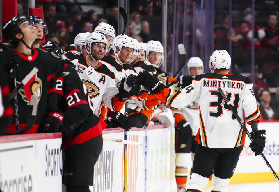 Anaheim Ducks defenseman Pavel Mintyukov (34) celebrates with his bench after a first-period goal against the Ottawa Senators during NHL hockey game action in Ottawa, Ontario, Thursday, Feb. 15, 2024. (Sean Kilpatrick/The Canadian Press via AP)